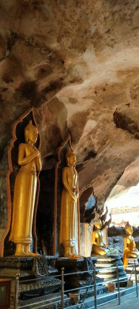 Golden Buddha statues inside the cave at Wat Suwanna Khuha