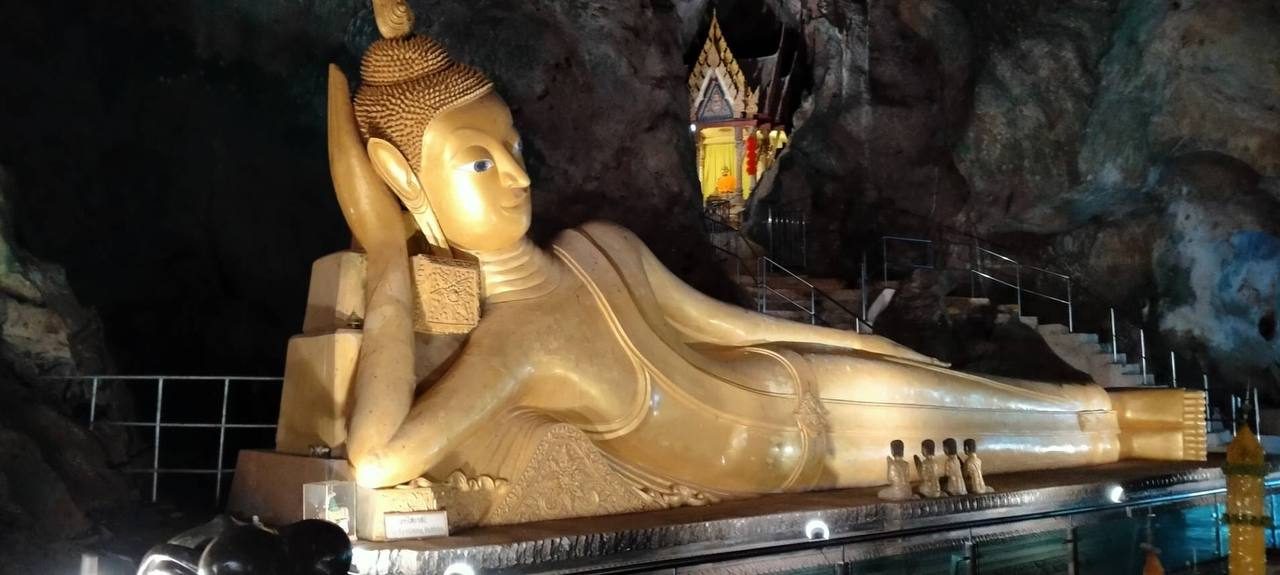 The reclining Buddha inside the cave at Wat Suwanna Khuha, the Monkey Temple