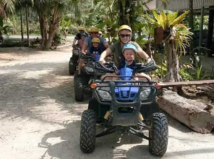 A family riding ATVs through the jungle on the Khao Lak Adventure and Nature tour