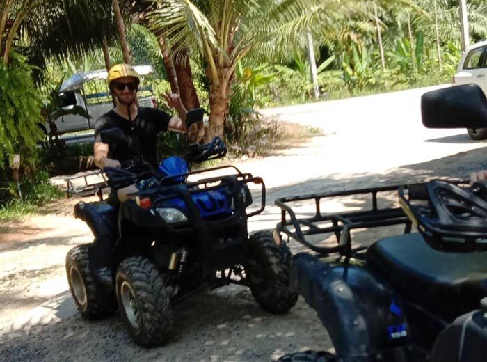 A guest posing on an ATV during the Khao Lak Adventure and Nature tour