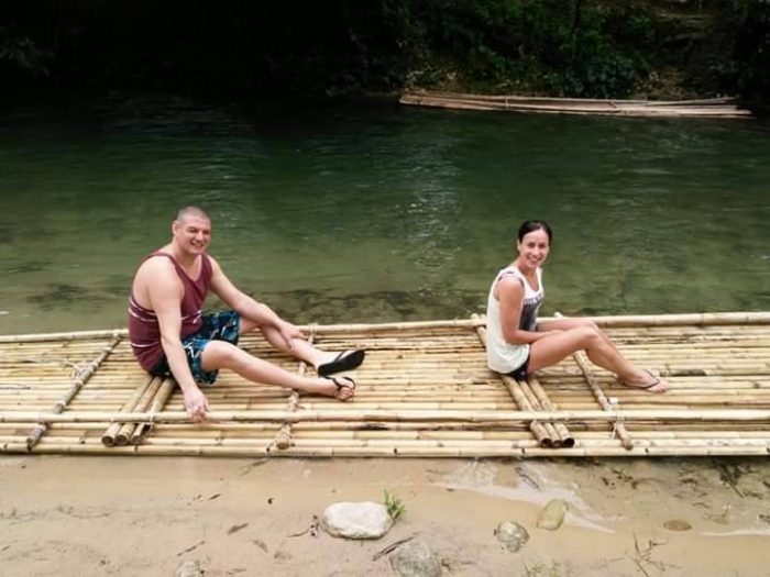 Guests relaxing on a bamboo raft on the river