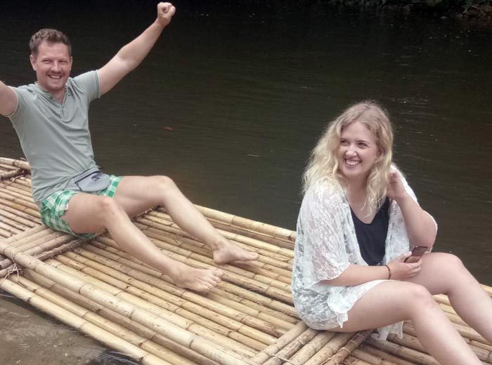 Guests celebrating on a bamboo raft after the ATV ride