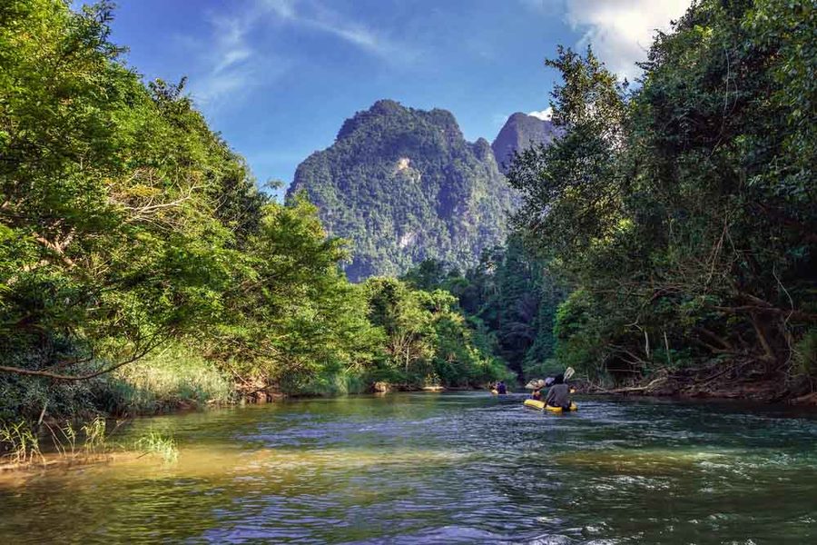 Bamboo rafting through Khao Sok, with limestone cliffs behind
