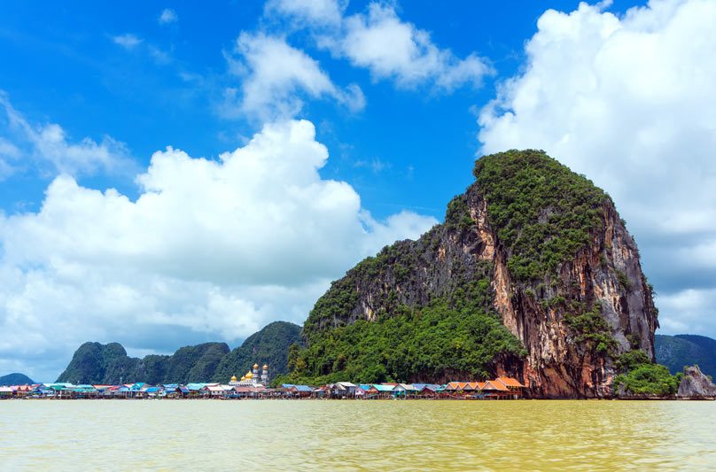 Floating fishing village at the base of a limestone island in Phang Nga Bay